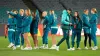 Australia’s head coach Tony Gustavsson (fourth right) walks around Stadium Australia with his players ahead of their opening