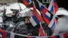 Police stand next to a restaurant decorated with Serbian flags ahead of the Euro 2024 Group C match against England (Markus 