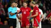 Referee Rohit Saggi speaks to Wales pair Aaron Ramsey and Ethan Ampadu in the goalless Nations League draw with Turkey (Davi