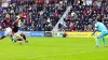 Hearts defender Jamie McCart scores his second own goal in the defeat to Rangers under pressure from Cyriel Dessers (Jane Ba