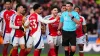 Referee Michael Oliver was confronted by Arsenal’s players after his decision to send off Myles Lewis-Skelly, right, at Moli